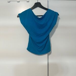 blue backless top with a sleek, minimalist silhouette.